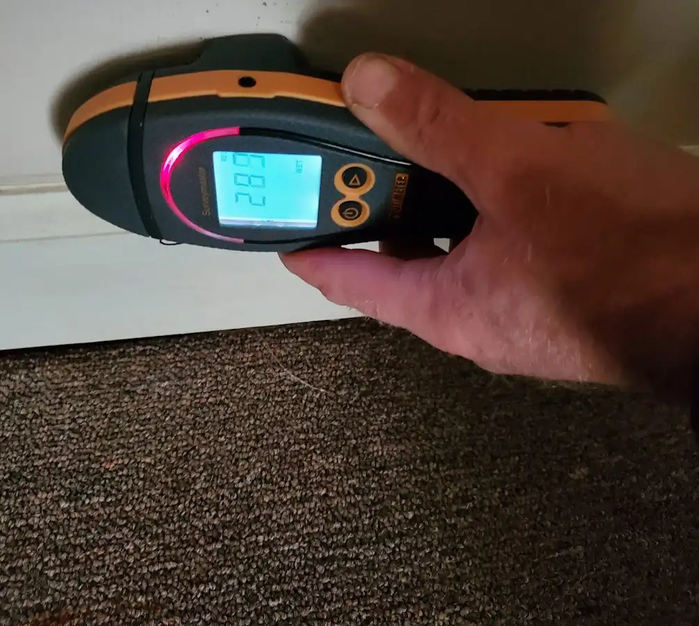 Moisture detection at baseboard during Storm Damage Restoration in Sheridan